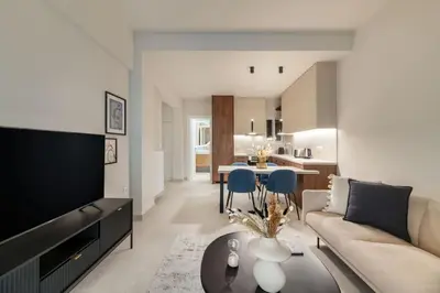 a living room with a couch and a table at Urban Elegance 2BR Apartment in Pangrati by UPSTREET in Athens