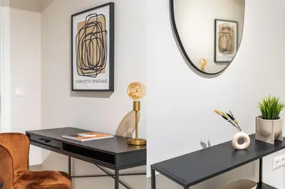 a desk in a room with a mirror and a chair at Urban Elegance 2BR Apartment in Pangrati by UPSTREET in Athens