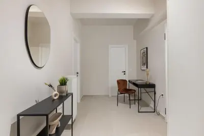 a room with a mirror and a table and chairs at Urban Elegance 2BR Apartment in Pangrati by UPSTREET in Athens