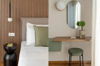a bedroom with a bed and a mirror and a stool at Urban Elegance 2BR Apartment in Pangrati by UPSTREET in Athens