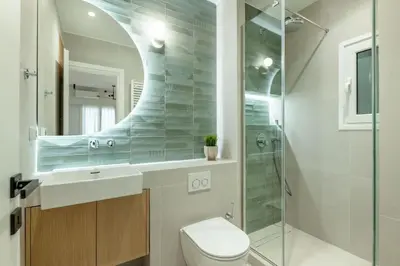 a bathroom with a toilet and a sink and a shower at Urban Elegance 2BR Apartment in Pangrati by UPSTREET in Athens