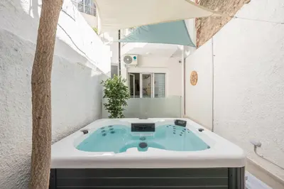 a bath tub in a bathroom with a tree at The Place to Be Kastella Exclusive in Piraeus