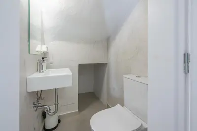a white bathroom with a toilet and a sink at The Place to Be Kastella Exclusive in Piraeus
