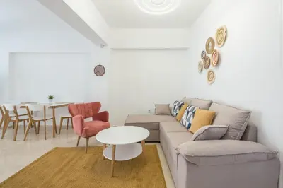 a living room with a couch and a table at The Place to Be Kastella Exclusive in Piraeus