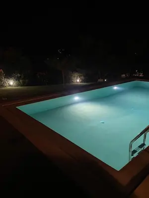 a swimming pool at night with lights at RELAXING POOL HOUSE IN LAGONISI 2 in Kalívia Thorikoú