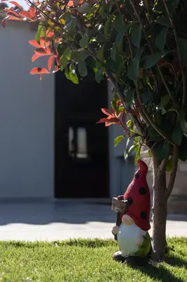 a stuffed animal sitting next to a tree at RELAXING POOL HOUSE IN LAGONISI 2 in Kalívia Thorikoú