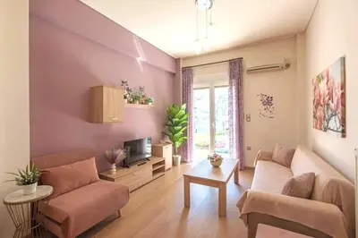 a living room with a couch and a tv at Sweet home in Zografou in Athens