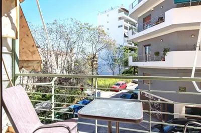 a balcony with a table and chairs on a building at Sweet home in Zografou in Athens