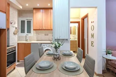 a kitchen and dining room with a table and chairs at Sweet home in Zografou in Athens