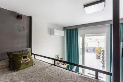 a bedroom with a large mirror on the wall at Smart-Stay Acropolis View in Athens
