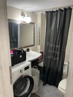 a bathroom with a sink and a washing machine at Maria's luxury apartment in Athens