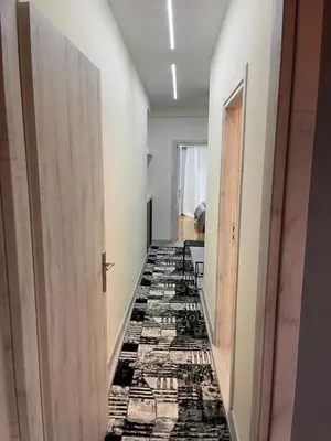 a hallway with a black and white flooring at Maria's luxury apartment in Athens