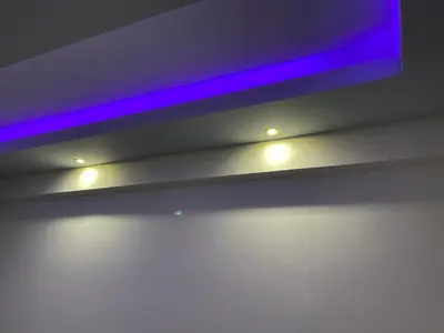 a tv hanging from a ceiling with lights on it at Maria's luxury apartment in Athens
