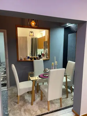 a dining room with a glass table and white chairs at Maria's luxury apartment in Athens