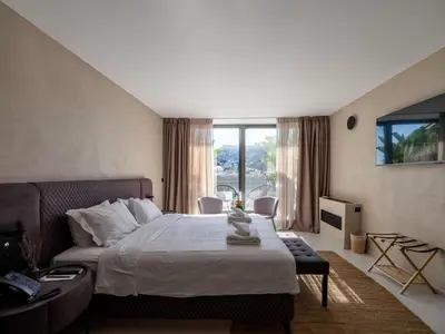 a bedroom with a bed and a large window at Regal Hotel Mitropoleos in Athens