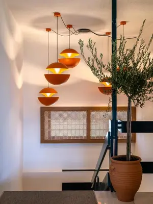 a room with a potted plant on a table with lights at Regal Hotel Mitropoleos in Athens