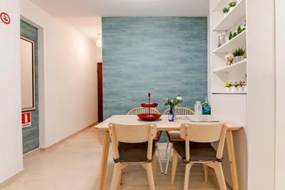 a dining room with a table and chairs at Quiet simple brand new luxury apartment by the sea in Athens