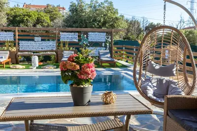 a table with flowers on it next to a pool at RELAXING POOL HOUSE IN LAGONISI 1 in Kalívia Thorikoú