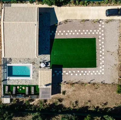 an overhead view of a yard with a swimming pool at RELAXING POOL HOUSE IN LAGONISI 1 in Kalívia Thorikoú