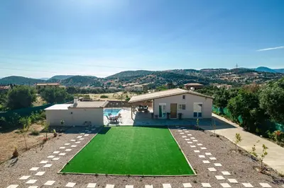 an aerial view of a house with a green lawn at RELAXING POOL HOUSE IN LAGONISI 1 in Kalívia Thorikoú