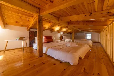 a large bed in a room with wooden ceilings at RELAXING POOL HOUSE IN LAGONISI 1 in Kalívia Thorikoú