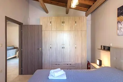 a bedroom with a blue bed and a wooden cabinet at Stunning and spacious apt in Athens in Athens