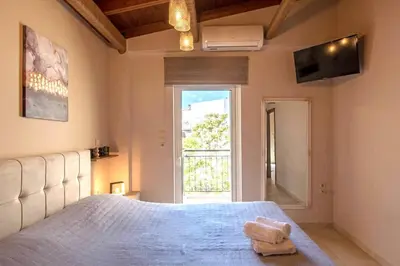 a bedroom with a bed and a large window at Stunning and spacious apt in Athens in Athens