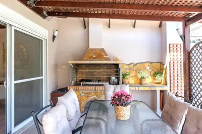 a patio with a table and chairs and a fireplace at Stunning and spacious apt in Athens in Athens