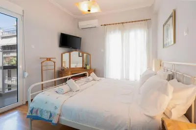 a white bedroom with a bed and a window at Vintage 1BR in Exarchia Timeless in Athens