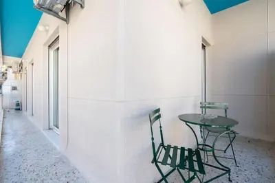 a table and chairs in a room with a wall at Vintage 1BR in Exarchia Timeless in Athens
