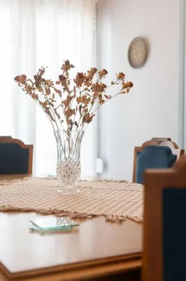 a vase of flowers sitting on top of a table at Vintage 1BR in Exarchia Timeless in Athens
