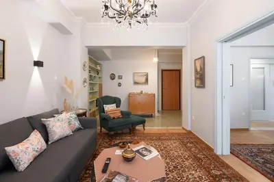 a living room with a couch and a table at Vintage 1BR in Exarchia Timeless in Athens