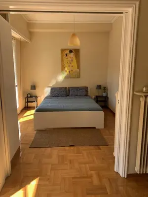 a bedroom with a bed with a blue blanket at Charming Plaka Retreat in the Heart of Historic old Athens city in Athens
