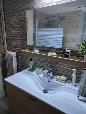 a bathroom with a white sink and a mirror at Fully furnished apartment in the heart of Athens in Athens