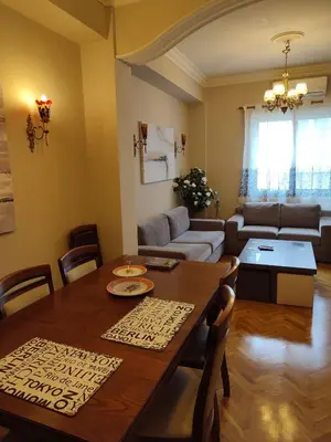 a living room with a table and a couch at Cosy flat in the heart of Athens in Athens