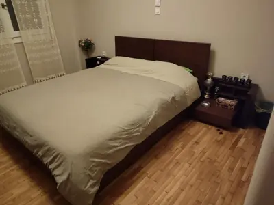 a large bed in a bedroom with a wooden floor at Cosy flat in the heart of Athens in Athens