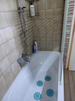 a bath tub with a faucet in a bathroom at Cosy flat in the heart of Athens in Athens