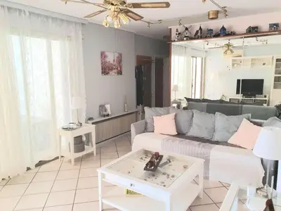 a living room with a couch and a table at Kavouri Seaside 85sqm Apartment 5' from the beach in Athens