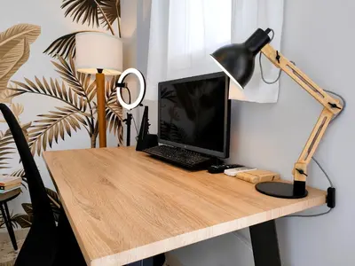 a desk with a laptop computer and a lamp on it at Artemonos Loft Acropolis View in Athens