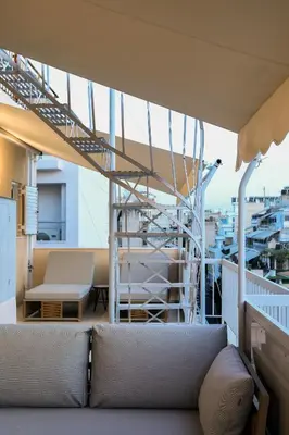 a couch sitting on a balcony with a staircase at Artemonos Loft Acropolis View in Athens