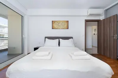 a bedroom with a large white bed with two white pillows at Seaside Breeze - 2 Bdrm Apartment in Palaio Faliro - Sea View in Athens