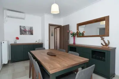 a dining room with a wooden table and a mirror at Seaside Breeze - 2 Bdrm Apartment in Palaio Faliro - Sea View in Athens