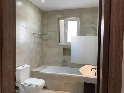 a bathroom with a tub and a toilet and a sink at Seaside Breeze - 2 Bdrm Apartment in Palaio Faliro - Sea View in Athens