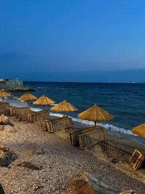 a group of chairs and umbrellas on a beach at Seaside Breeze - 2 Bdrm Apartment in Palaio Faliro - Sea View in Athens