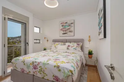 a bedroom with a large bed and a window at Vouliagmeni - Apollonos Street in Athens