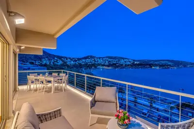 a balcony with a view of the water at Vouliagmeni - Apollonos Street in Athens