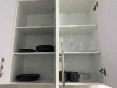 a white cabinet with plates and glasses on it at FEELS LIKE HOME in Athens