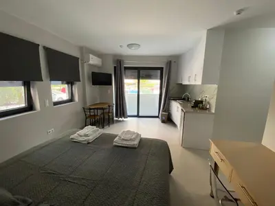 a small room with a bed and a kitchen at FEELS LIKE HOME in Athens