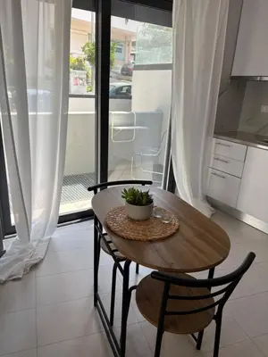a kitchen with a wooden table and two chairs and a table at FEELS LIKE HOME in Athens
