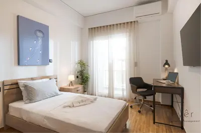 a bedroom with a bed and a desk and a computer at Comfort Oasis: Work-Friendly Space w/Fiber Net in Athens